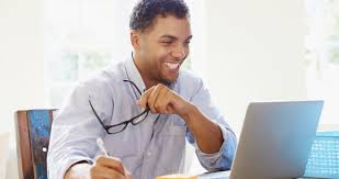 man smiling at computer 